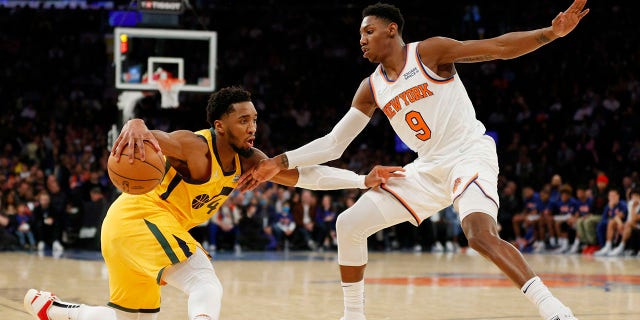 Donovan Mitchell, #45 of the Utah Jazz, dribbles against RJ Barrett, #9 of the New York Knicks, during the second half at Madison Square Garden on March 20, 2022 in New York City. The Jazz won 108-93.