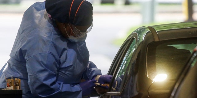 An employee of Westchester Medical Center applies a monkeypox vaccine to a person at a drive-through vaccination center for monkeypox at Westchester Medical Center in Valhalla, New York, US, July 28, 2022. 