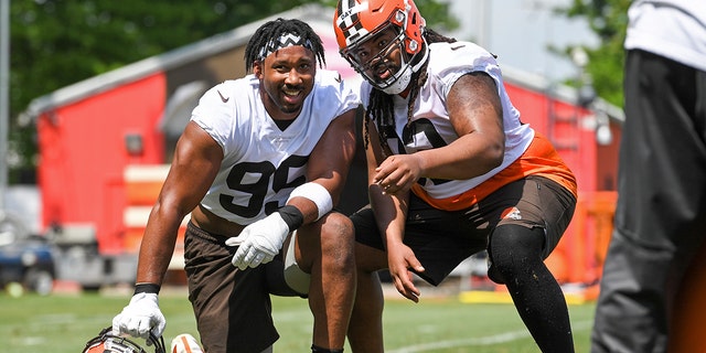 Myles Garrett (95) and Sheldon Day of the Cleveland Browns pose for a photo during the Cleveland Browns' offseason workout at CrossCountry Mortgage Campus on June 1, 2022, in Berea, Ohio.