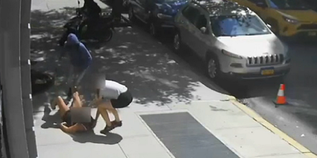One of the victims is seen kicking at the suspect in the Upper East Side neighborhood during the robbery attempt.