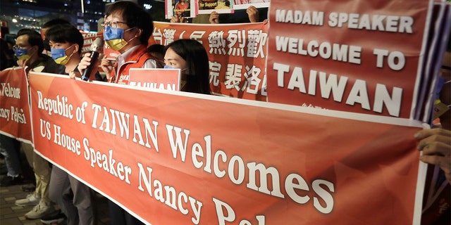 Supporters hold a banner outside the hotel where U.S. House Speaker Nancy Pelosi is supposed to be staying in Taipei, Taiwan, Tuesday, Aug 2, 2022.