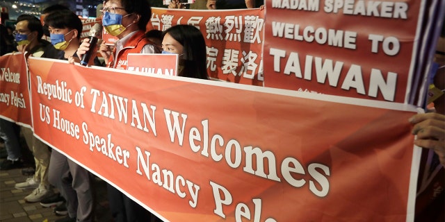 Supporters hold a banner outside the hotel where House Speaker Nancy Pelosi is supposed to be staying in Taipei, Taiwan, Tuesday, Aug 2, 2022.