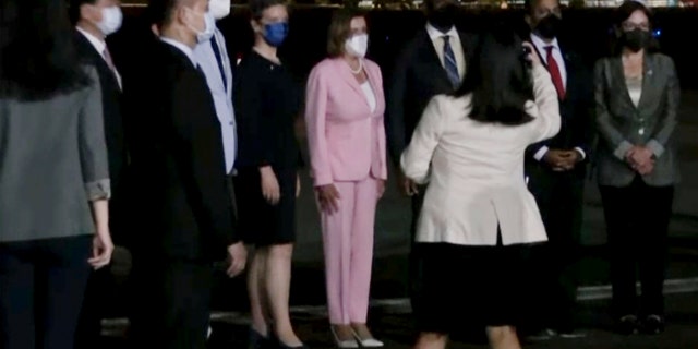 In this image taken from video, U.S. House Speaker Nancy Pelosi, center, arrives in Taipei, Taiwan, Tuesday, Aug. 2, 2022.