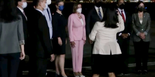 In this image taken from video, U.S. House Speaker Nancy Pelosi, center, arrives in Taipei, Taiwan, Tuesday, Aug. 2, 2022.