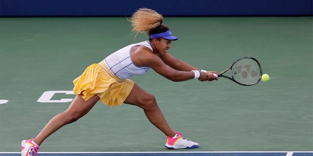 Naomi Osaka, of Japan, reaches for a shot from Zheng Qinwen, of China, at the Mubadala Silicon Valley Classic tennis tournament in San Jose, Calif., Tuesday, Aug. 2, 2022.