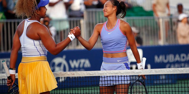 Naomi Osaka, of Japan, left, shakes hands after her win with Zheng Qinwen, of China, during their first round match at the Mubadala Silicon Valley Classic tennis tournament in San Jose, Calif., Tuesday, Aug. 2, 2022. 