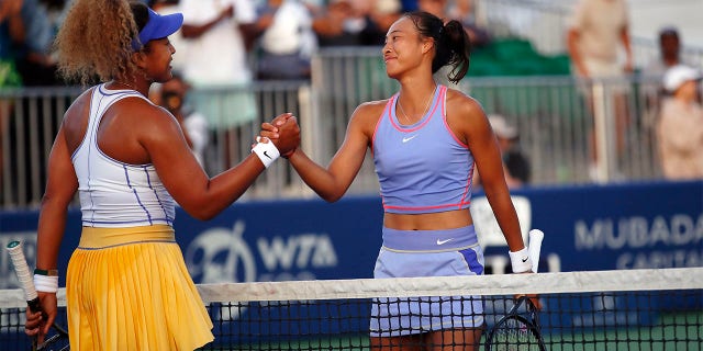 Naomi Osaka, of Japan, left, shakes hands after her win with Zheng Qinwen, of China, during their first round match at the Mubadala Silicon Valley Classic tennis tournament in San Jose, Calif., Tuesday, Aug. 2, 2022.