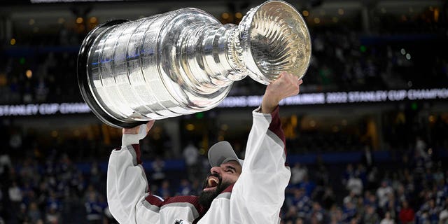 Nazem Kadori of the Colorado Avalanche Center lifts the Stanley Cup after the team defeated the Tampa Bay Lightning in Game 6 of the Stanley Cup Finals on June 26, 2022 in Tampa, Florida.