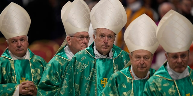 Newly created Cardinal Robert Walter McElroy, third from left, bishop of San Diego, leaves at the end of a Mass for the new cardinals celebrated by Pope Francis at St. Peter's Basilica in the Vatican Tuesday, Aug. 30, 2022.
