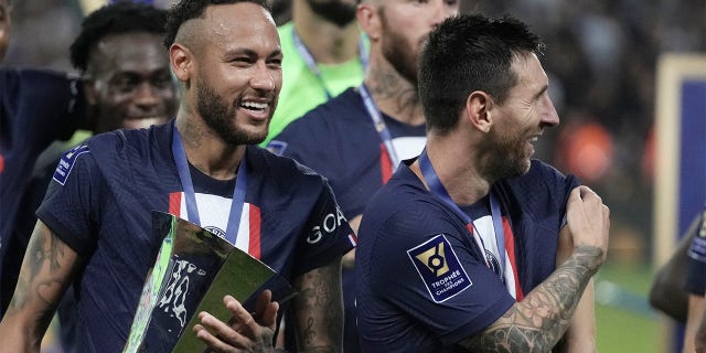 PSG's Neymar (left) holds the trophy as he celebrates with his teammate Lionel Messi after winning the French Super Cup football final between Nantes and Paris Saint-Germain at the Bloomfield Stadium in Tel Aviv, Israel on Sunday , July 31, 2022. PSG won 4-0.