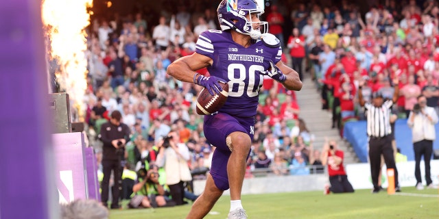 Northwestern wide receiver Donny Navarro III (80) celebrates after catching a 6-yard touchdown pass during the first half of an NCAA college football game against Nebraska, Saturday, Aug. 27, 2022, at Aviva Stadium in Dublin, Ireland.