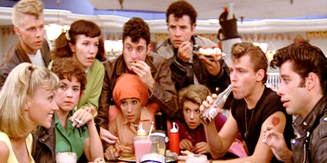 LOS ANGELES - JUNE 16: The movie "Grease", directed by Randal Kleiser. Seen here at the malt shop, the Pink Ladies and the T-Birds. In back from left, Kelly Ward (as Putzie), Jamie Donnelly (as Jan), Barry Pearl (as Doody) and Michael Tucci (as Sonny). Seated, from left, Olivia Newton-John (as Sandy), Stockard Channing (as Rizzo), Didi Conn (as Frenchy), Dinah Manoff (as Marty), Jeff Conaway (as Kenickie) and John Travolta (as Danny). Initial theatrical release of the film, June 16, 1978. Screen capture. Paramount Pictures. (Photo by CBS via Getty Images)