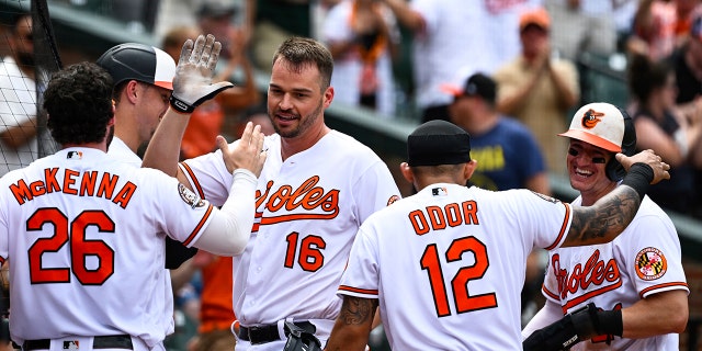 Baltimore Orioles designated hitter Trey Mancini (16) is greeted by teammates after hitting an inside-the-park home run during the eighth inning against the Tampa Bay Rays July 28, 2022, in Baltimore.