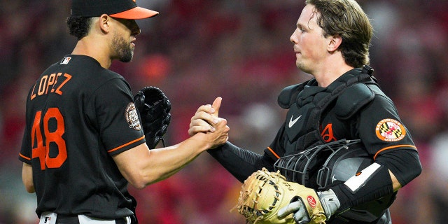 Baltimore Orioles relief pitcher Jorge López (48) celebrates with catcher Adley Rutschman after the team's win over the Cincinnati Reds July 29, 2022, in Cincinnati.