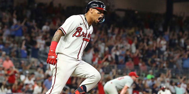 Atlanta Braves second baseman Orlando Arcia reacts to his two-RBI home run off Philadelphia Phillies pitcher Corey Knebell who watches it leave the park during the fifth inning of a baseball game, Tuesday, Aug. 2, 2022 in Atlanta. 