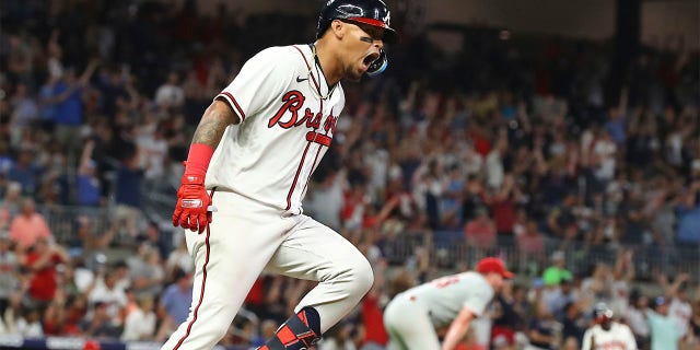 Atlanta Braves second baseman Orlando Arcia reacts to his two-RBI home run off Philadelphia Phillies pitcher Corey Knebell who watches it leave the park during the fifth inning of a baseball game, Tuesday, Aug. 2, 2022 in Atlanta.