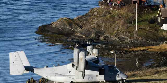 A United States' V-22 Osprey, a multi-mission, tiltrotor military aircraft with both vertical takeoff and landing, lands to pick up Marines during a joint demonstration as part of the NATO Trident Juncture 2018 exercise in Byneset near Trondheim, Norway, on Oct. 30, 2018.