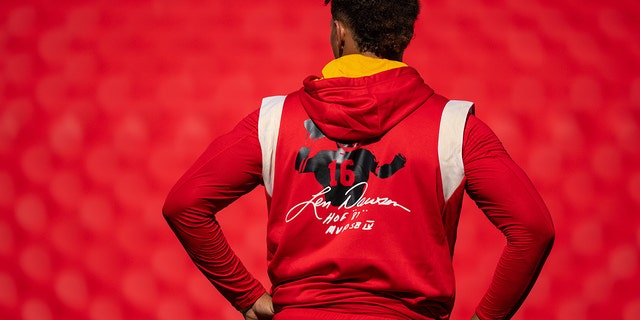 Patrick Mahomes of the Kansas City Chiefs stands on the field during warmups for a preseason game against the Green Bay Packers at Arrowhead Stadium Aug. 25, 2022, in Kansas City, Mo. He's wearing a sweatshirt in tribute to NFL Hall of Fame quarterback Len Dawson after Dawson's recent death.  