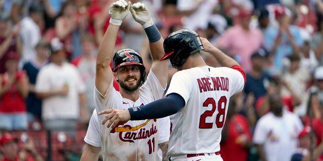 St. Louis Cardinals' Paul DeJong (11) is congratulated by teammate Nolan Arenado (28) after hitting a three-run home run during the eighth inning of a baseball game against the New York Yankees Sunday, Aug. 7, 2022, in St. Louis.