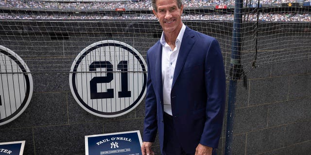 Retired New York Yankees player Paul O'Neill stands next to his number in Monument Park during a farewell ceremony for a baseball game between the Yankees and Toronto Blue Jays, Sunday, August 21, 2022 in New York.