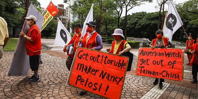 Pro-China demonstrators protest outside the Grand Hyatt hotel ahead of the arrival of US House Speaker Nancy Pelosi in Taipei, Taiwan, on Tuesday, Aug. 2, 2022.