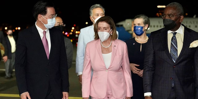 Speaker of the House Nancy Pelosi walks with Taiwan Foreign Minister Joseph Wu, left, as she arrives in Taipei, Taiwan, Tuesday, August 28.  2, 2022.