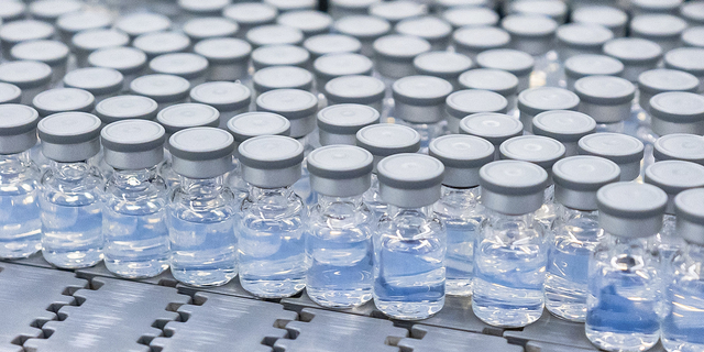 This August 2022 photo shows vials of Pfizer's updated COVID-19 vaccine during production in Kalamazoo, Michigan. 