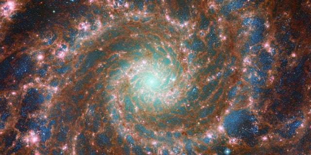 The M74 galaxy shines at its brightest in this combined optical/mid-infrared image, featuring data from both the NASA/ESA Hubble Space Telescope and the NASA/ESA/CSA James Webb Space Telescope. With Hubble’s venerable Advanced Camera for Surveys (ACS) and Webb’s powerful Mid-InfraRed Instrument (MIRI) capturing a range of wavelengths, this image has remarkable depth.