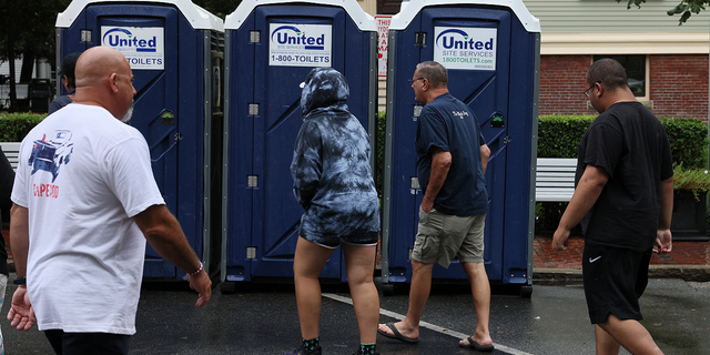 People head for porta-potties on Thursday, Aug. 11, that were installed on Ryder Street temporarily as Provincetown officials contend with a sewer overflow.