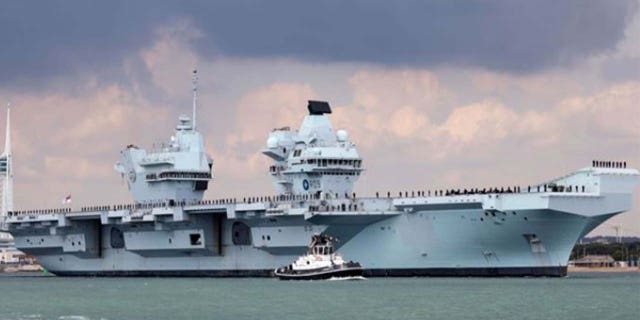 A photo of the HMS Prince of Wales anchored near harbor.