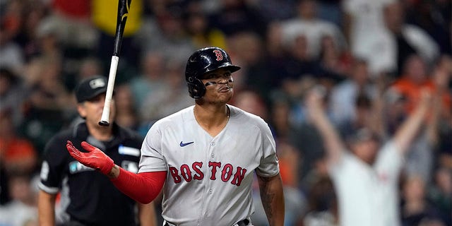 Rafael Devers of the Boston Red Sox hoists his bat after hitting a home run against the Houston Astros during the sixth inning of a baseball game on Tuesday, Aug. 2, 2022, in Houston. 