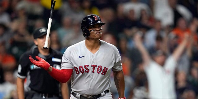 Boston Red Sox's Rafael Devers flips his bat after hitting a home run against the Houston Astros during the sixth inning of a baseball game Tuesday, Aug. 2, 2022, in Houston.