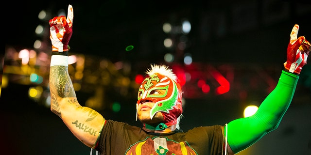 Rey Mysterio gestures to the crowd.