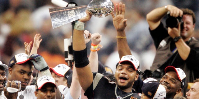 New England Patriots' Richard Seymour holds the Vince Lombardi Trophy after the Patriots defeated the Carolina Panthers 32-29 to win Super Bowl XXXVIII on Feb. 1, 2004, in Houston.