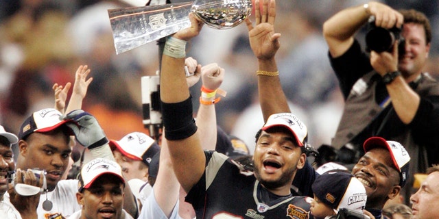 New England Patriots' Richard Seymour holds the Vince Lombardi Trophy after the Patriots defeated the Carolina Panthers 32-29 to win Super Bowl XXXVIII on Feb. 1, 2004, in Houston.