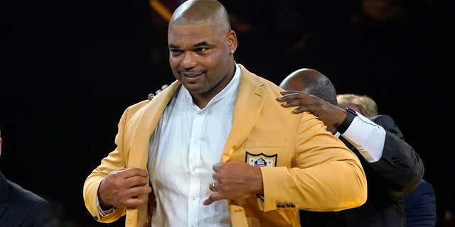 Richard Seymour, a member of the Pro Football Hall of Fame Class of 2022, receives his gold jacket in Canton, Ohio, Friday, Aug. 5, 2022.