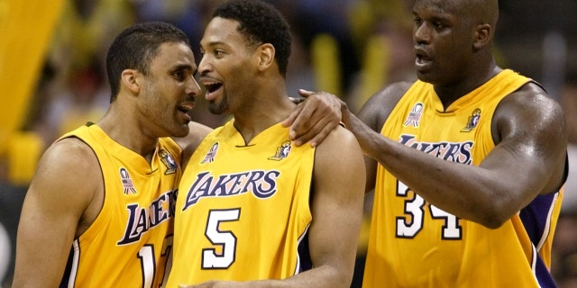 Los Angeles Lakers' Rick Fox (L), Robert Horry, #5, and Shaquille O'Neal celebrate against the New Jersey Nets during Game 2 of the NBA Finals June 7, 2002 in Los Angeles.