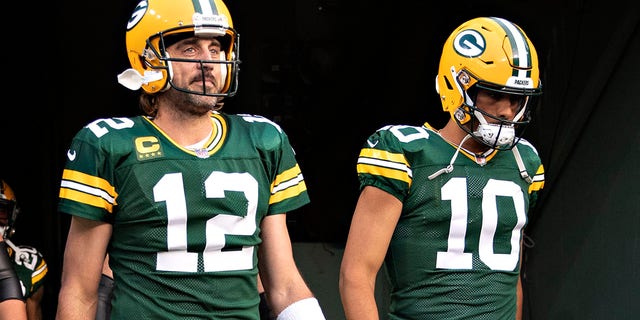 Aaron Rodgers,left, and Jordan Love of the Green Bay Packers walk onto the field before a game against the Detroit Lions at Lambeau Field in Green Bay, Wisconsin, on Sept. 20, 2021.