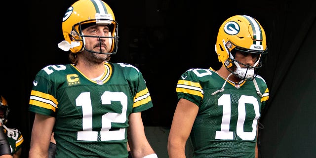 Aaron Rodgers,left, and Jordan Love of the Green Bay Packers walk onto the field before a game against the Detroit Lions at Lambeau Field in Green Bay, Wisconsin, on Sept. 20, 2021.