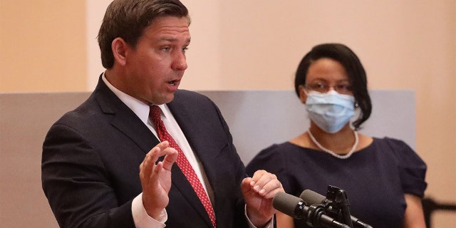 Gov. Ron DeSantis announces the appointment of Renatha Francis, right, a Palm Beach County circuit judge, to the Florida Supreme Court during a news conference, May 26, 2020, in downtown Miami.