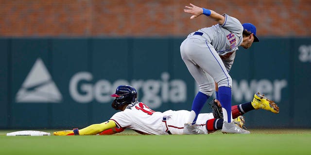 Atlanta Braves' Ronald Acuna Jr. (13) is tagged out by New York Mets' Jeff McNeil (1) on a stolen base attempt in the third inning at Troost Park August 16, 2022 in Atlanta.