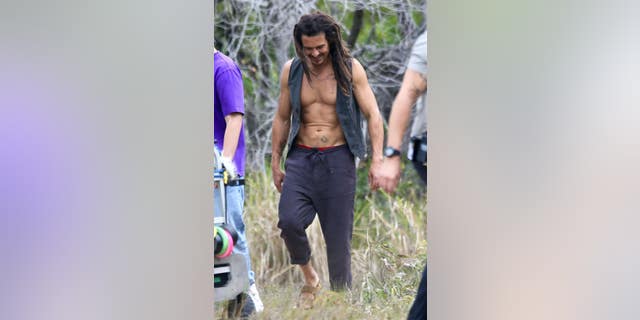 Bloom showed off his washboard abs while on set.