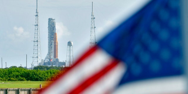 An American flag waves in the breeze as NASA's New Moon rocket lands on launch pad 39-B Tuesday, Aug. 30, 2022, in Cape Canaveral, Florida.