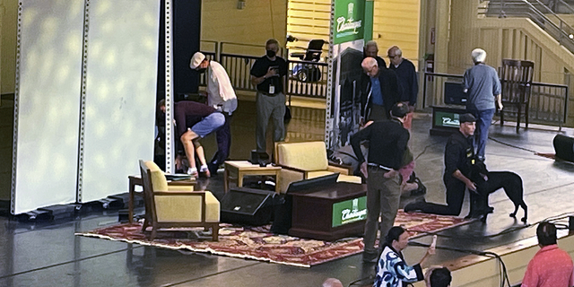 Author Salman Rushdie, behind the screen on the left, is accused of being attacked during a conference on Friday, August 12 at the Chautauqua Institution in Chautauqua, New York.