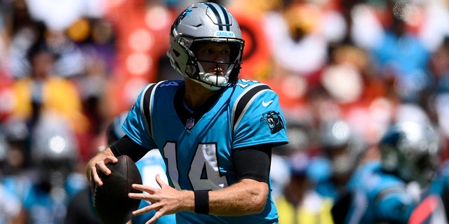 Carolina Panthers quarterback Sam Darnold, #14, looks to pass during the first half of a preseason NFL football game against the Washington Commanders, Saturday, Aug. 13, 2022, in Landover, Maryland.