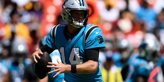 Carolina Panthers quarterback Sam Darnold, #14, looks to pass during the first half of a preseason NFL football game against the Washington Commanders, Saturday, Aug. 13, 2022, in Landover, Maryland.