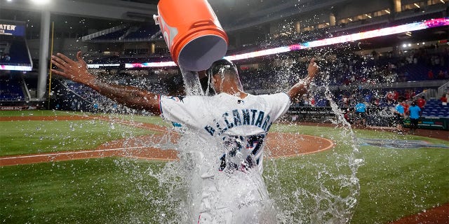 Miami Marlins starting pitcher Sandy Alcantara is doused by Pablo Lopez after the Marlins beat the Cincinnati Reds 3-0 in a baseball game, Wednesday, Aug. 3, 2022, in Miami.