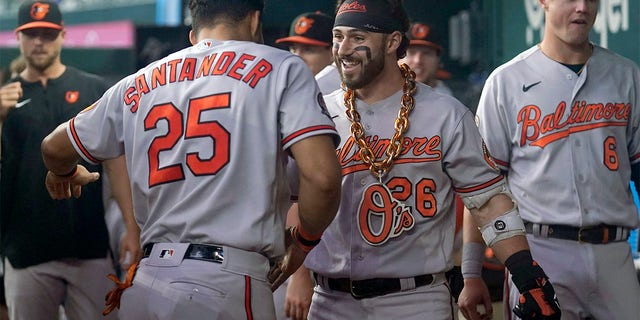 Baltimore Orioles' Anthony Santander (25) and Ryan McKenna, right, celebrate affer McKenna hit a solo home run in the second inning of a baseball game against the Texas Rangers, Wednesday, Aug. 3, 2022, in Arlington, Texas. 