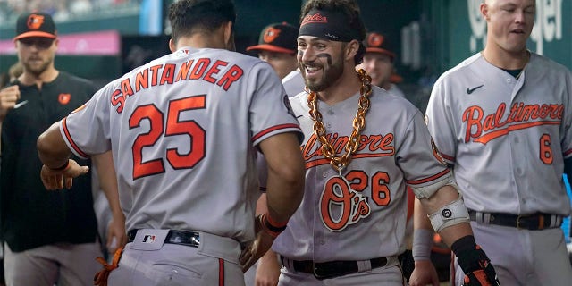 Baltimore Orioles' Anthony Santander (25) and Ryan McKenna, right, celebrate affer McKenna hit a solo home run in the second inning of a baseball game against the Texas Rangers, Wednesday, Aug. 3, 2022, in Arlington, Texas.