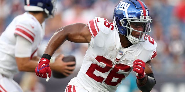 Saquon Barkley (26) of the New York Giants runs a route during a preseason game against the New England Patriots at Gillette Stadium Aug. 11, 2022, in Foxborough, Mass.
